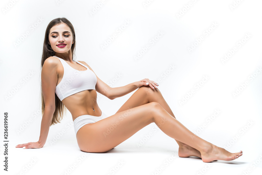 Young woman in white underwear sitting on floor