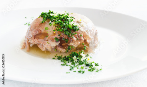 beef jelly decorated with parsley, dill, and garlic