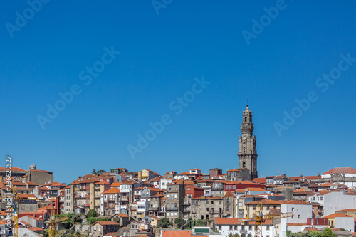 View at the Clerigos tower, baroque icon on Porto city, buildings and blue sky