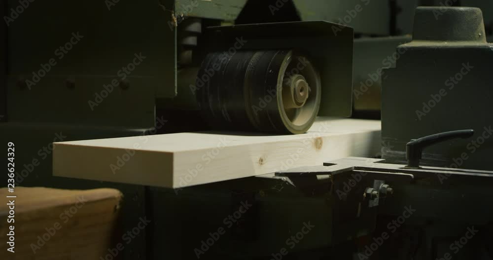 Macro close up of professional carpenter working on woodworking machines in a workshop of wood factory. Macro close up of professional carpenter working on woodworking machines in a workshop of wood factory.