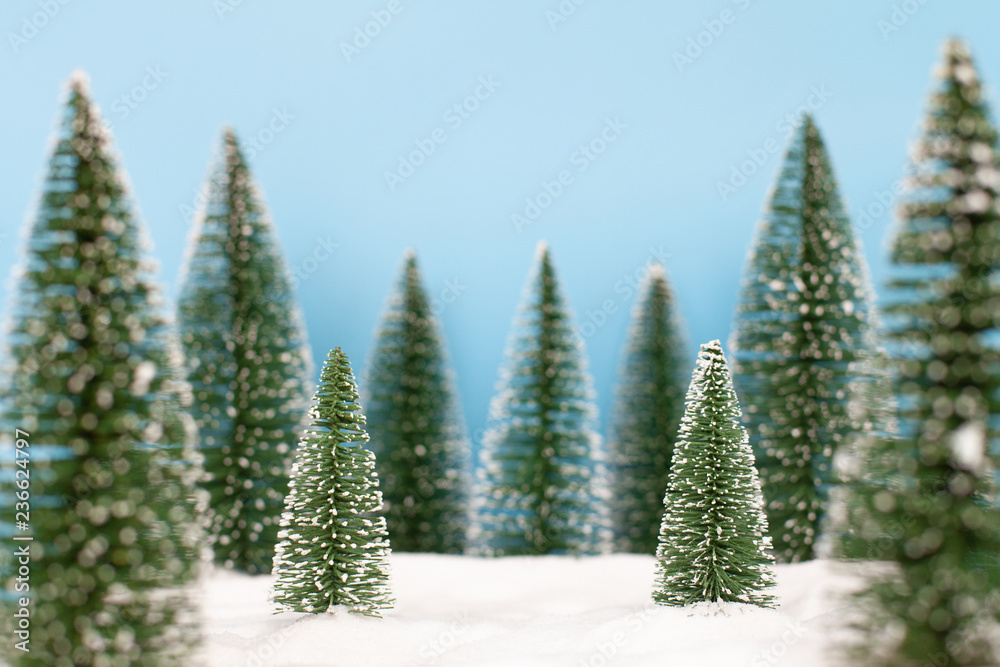 Obraz premium Landscape forest with christmas trees on the snow in winter. Christmas holiday celebration and new year concept. copy space
