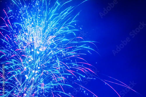Brightly Colorful Fireworks on twilight background with copy space