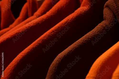 colorful fleece jackets, colorful polar fleece jackets on a hanger macro shot made of recycled plastic bottles photo