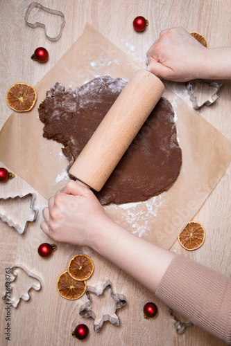 Rolling dough, baking gingerbread men, making christmas gingerbread cookies, cookie cutting, homemade traditional christmas dessert.