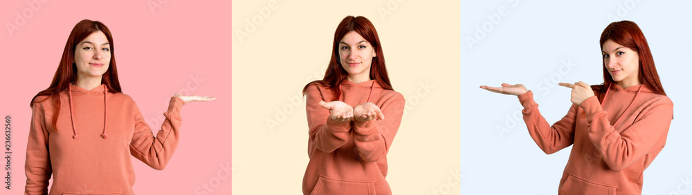 Set of Young redhead girl with pink sweatshirt holding copyspace imaginary on the palm to insert an ad on colorful background Set of Young redhead girl with pink sweatshirt holding copyspace imaginary on the palm to insert an ad on colorful background