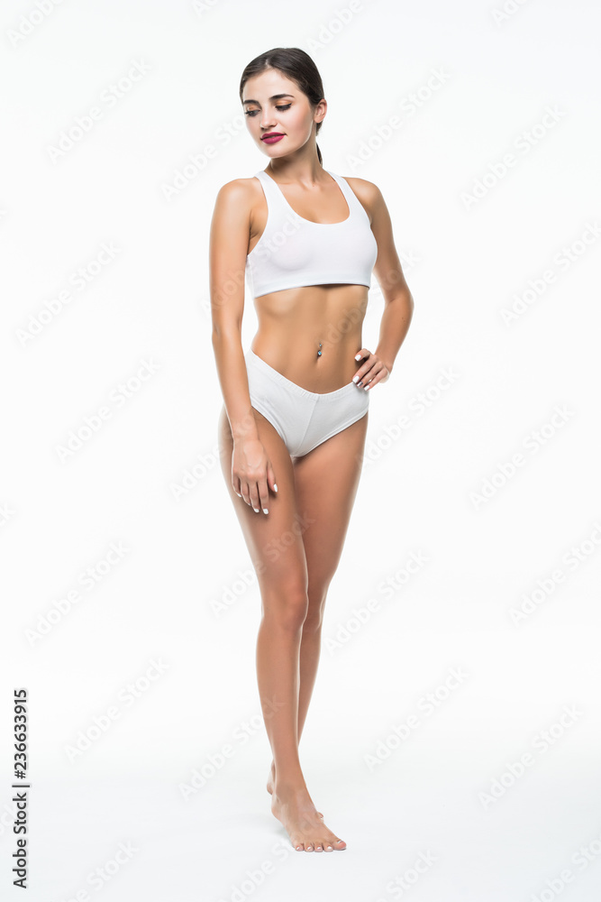 Happy young slim woman with beautiful perfect body posing on white background. Full-length portrait Happy young slim woman with beautiful perfect body posing on white background. Full-length portrait