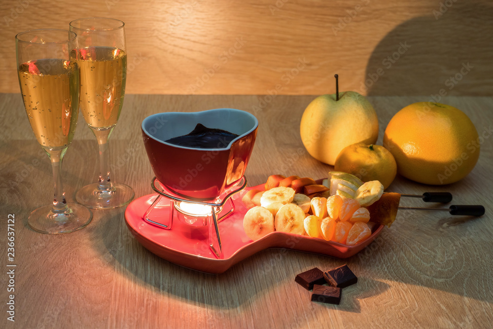Chocolate fondue with fruit and champagne. Romantic dinner. Love Chocolate fondue with fruit and champagne. Romantic dinner. Love
