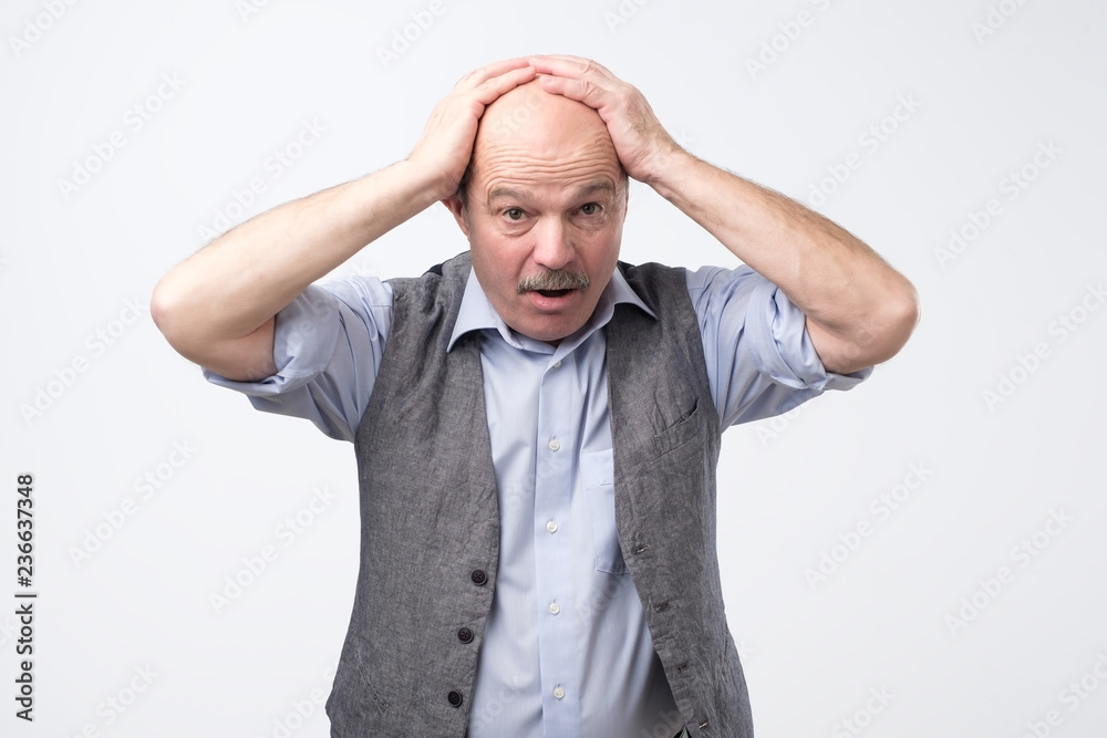 Senior man can not control panic and stress holding hands on head open mouth. Where are my keys concept. Senior man can not control panic and stress holding hands on head open mouth. Where are my keys concept.