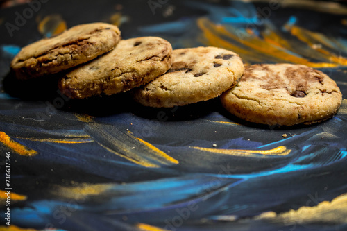 Vanilla cookies with chocolate chips on a blue and gold background.