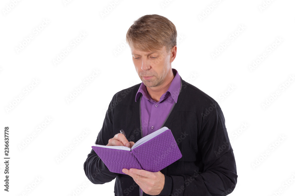 Portrait of middle age man dressed in cardigan writes in a notebook on white background Portrait of middle age man dressed in cardigan writes in a notebook on white background