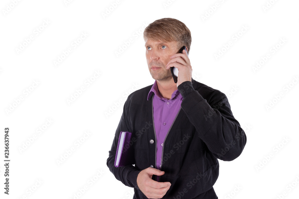 Portrait of middle aged man holding a notebook and talking on mobile phone over white background Portrait of middle aged man holding a notebook and talking on mobile phone over white background
