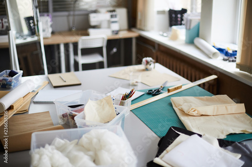 Tableau sur toile Workplace of tailor with assortment of fabric and other supplies for sewing