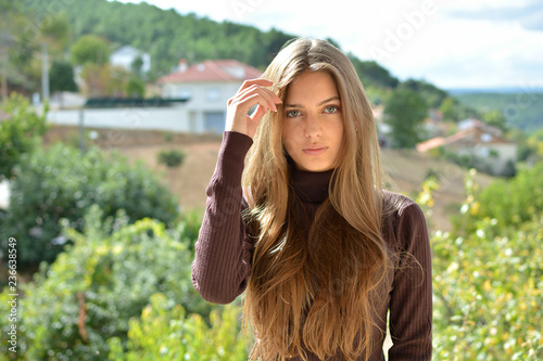 portrait of a beautiful ,healthy and attractive young woman with long hair and beautiful face with outdoor background