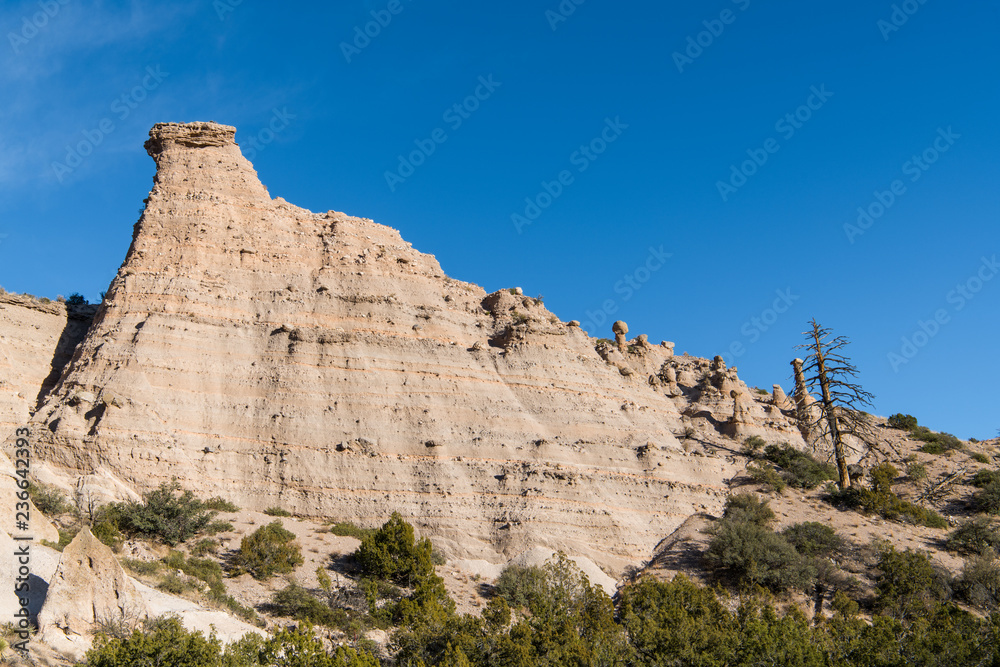 High, steep rock formation showing layers of strata at Kasha-Katuwe Tent Rocks National Monument