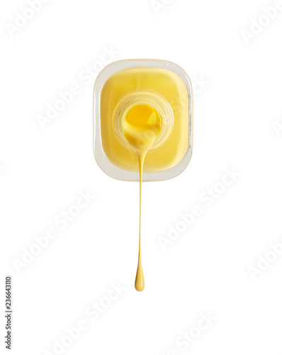 close up of a nail polish bottle and drop on white background