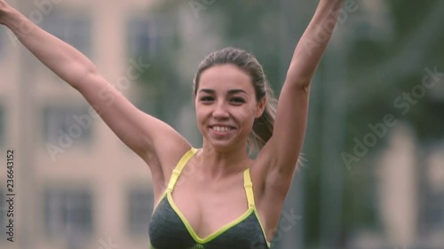 Fitness, sport, victory, success and healthy lifestyle concept - happy woman winning race and coming first to finish.