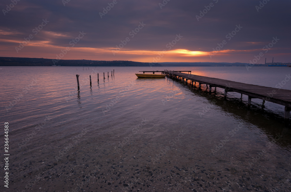 Seascape during sunset. Beautiful natural seascape, blue hour. Sea sunset at a lake coast near Varna, Bulgaria. Magnificent sunset with clouds in the middle of February.