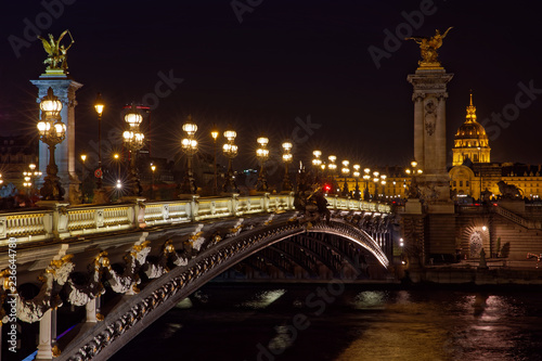 Paris, France - November 17, 2018: Alexandre 3 bridge and Invalide dome at night in Paris