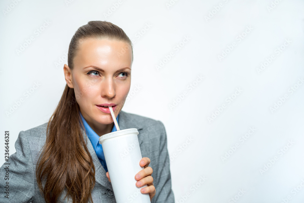 Business girl in a suit drinking soda water Business girl in a suit drinking soda water