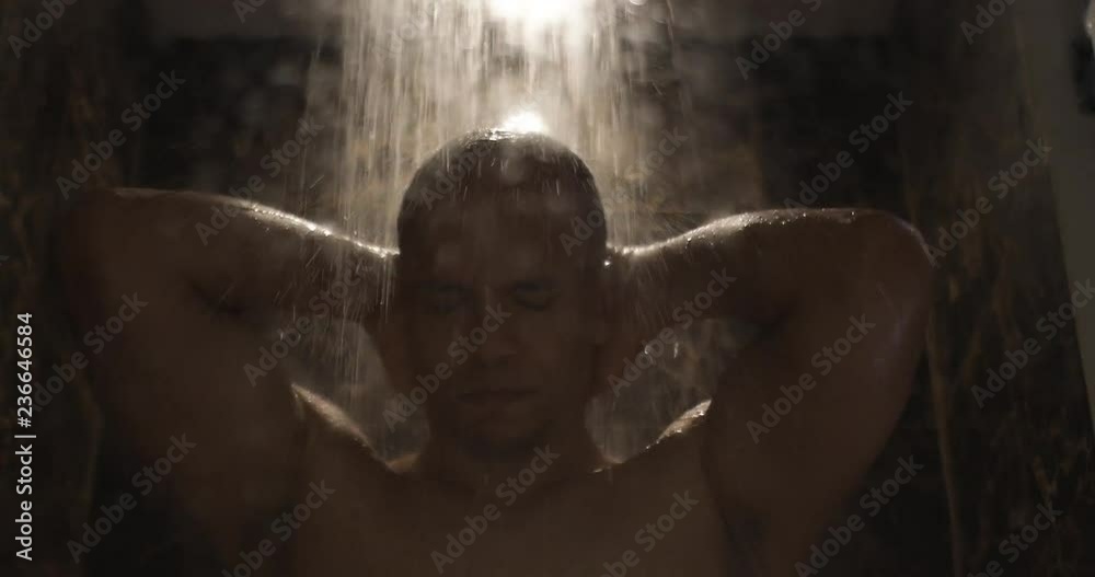 Mixed race man gets upset as he takes a shower