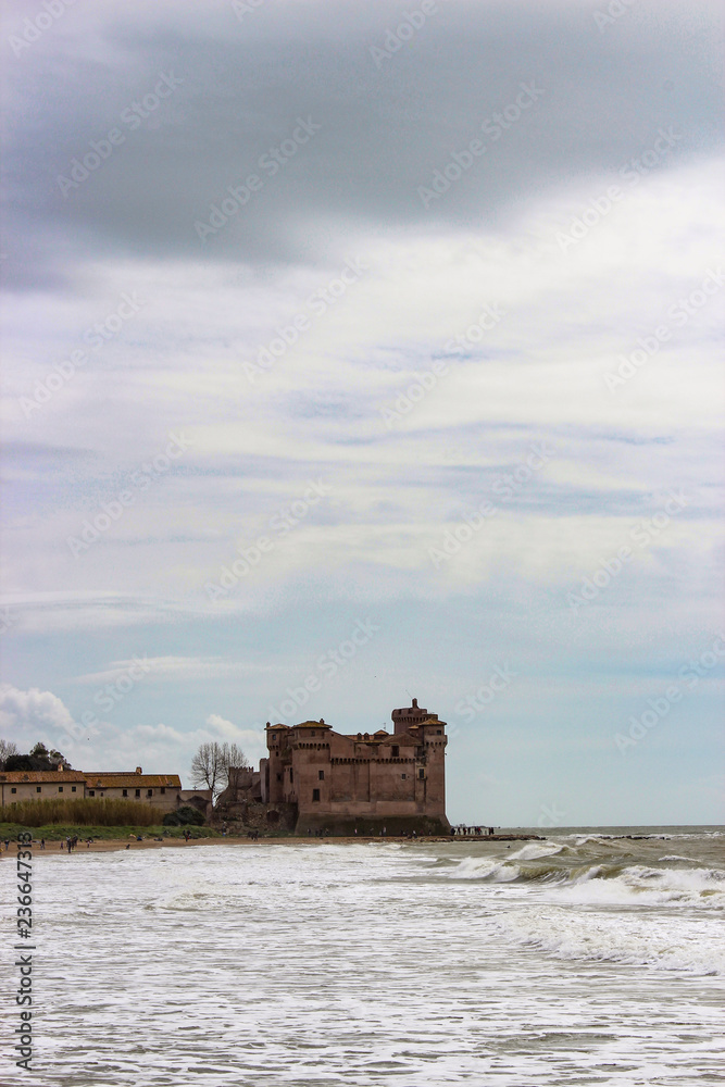 the castle of Santa Severa on a cold winter day. The cloudy white sky. In Lazio, Italy, Rome