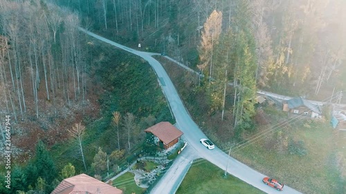 Aerial footage of supercars driving up mountain road photo