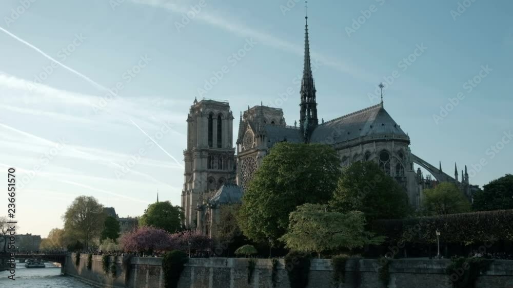 Camera still view of iconic Notre Dame Cathedral seen from the rear next to the Seine River in Paris, France Camera still view of iconic Notre Dame Cathedral seen from the rear next to the Seine River in Paris, France