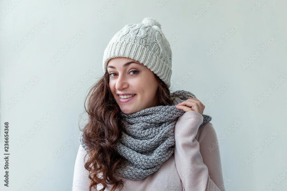 Beautiful woman winter portrait, true emotions. Laughing girl with long hair wearing warm clothes hat scarf isolated on white background. Young hipster girl looking happy and excited, having fun Beautiful woman winter portrait, true emotions. Laughing girl with long hair wearing warm clothes hat scarf isolated on white background. Young hipster girl looking happy and excited, having fun