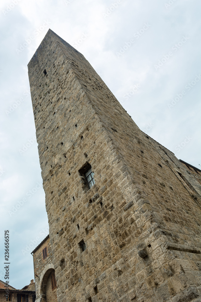 Spectacular stone built tower raising above medieval town.
