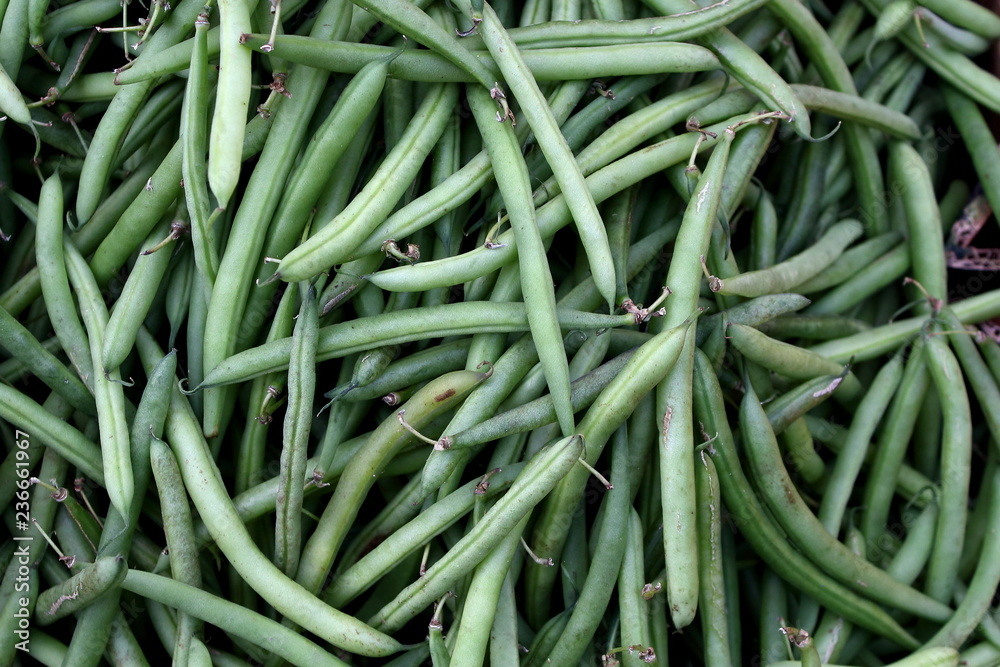 Lots of green fresh organic pea pods and string beans pattern background Lots of green fresh organic pea pods and string beans pattern background