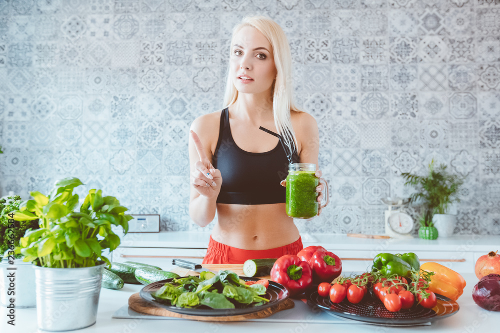 Young female blogger preparing green smoothie