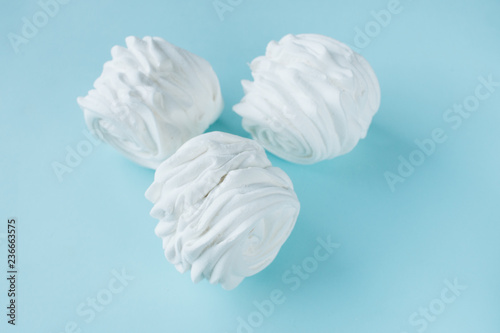 Delicious sweet marshmallows on blue background