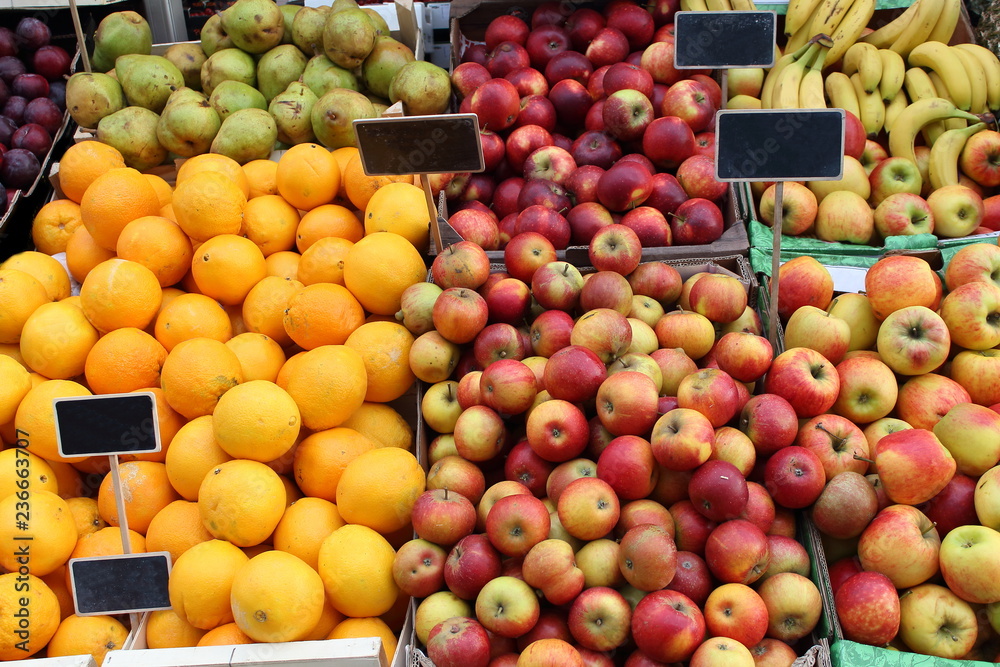 Lots of fresh organic red apples and juicy oranges on the market  pattern background