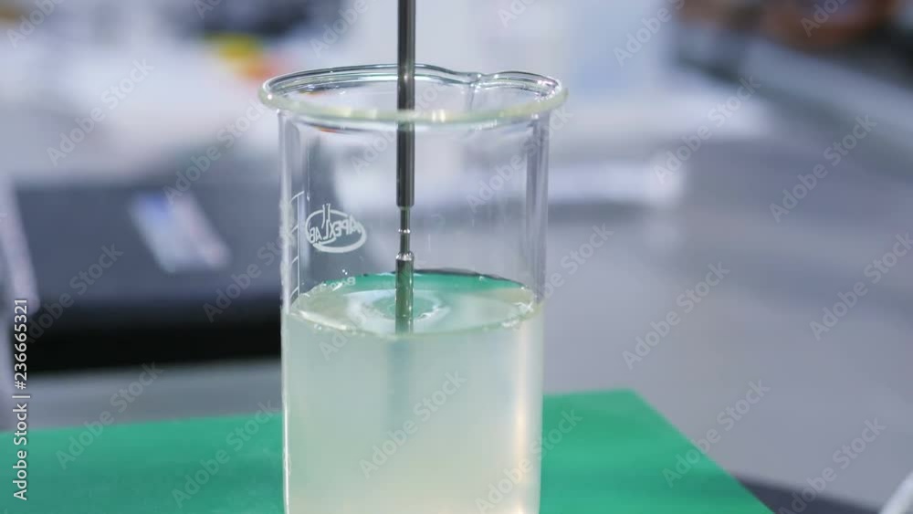 close view metal stick put into slime liquid in glass tube close view metal stick put into slime liquid in glass tube