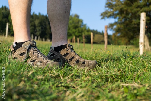 Man in sport shoes in the grass. Czech Republic photo