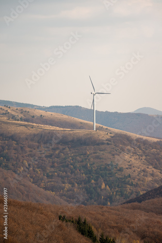 Wind turbines in the mountain, at a sunny autumn day