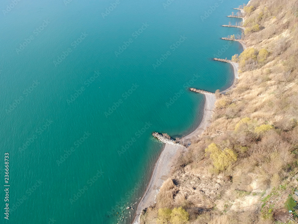 Aerial view of lake Ontario with bluffs and cliffs  area and  the beach of Toronto Greater Area at the calm day. Minimalistic panorama state of art. Bird eye view of the green water at sunny day.