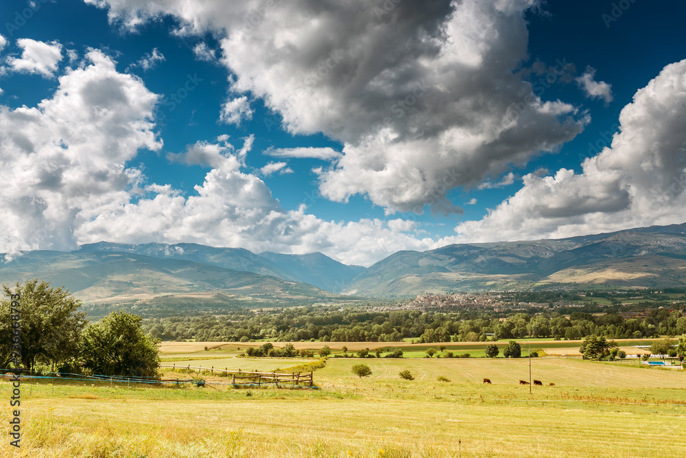 Scenic aerial view of the Mountain valley in the Pyrenees, with agricultural fields, villages and the city of Puigcerda Scenic aerial view of the Mountain valley in the Pyrenees, with agricultural fields, villages and the city of Puigcerda