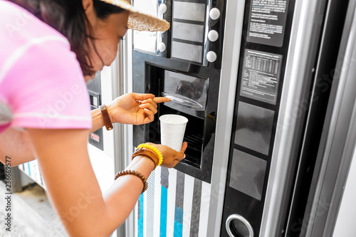 Foto woman buying coffee from automatic vending machine