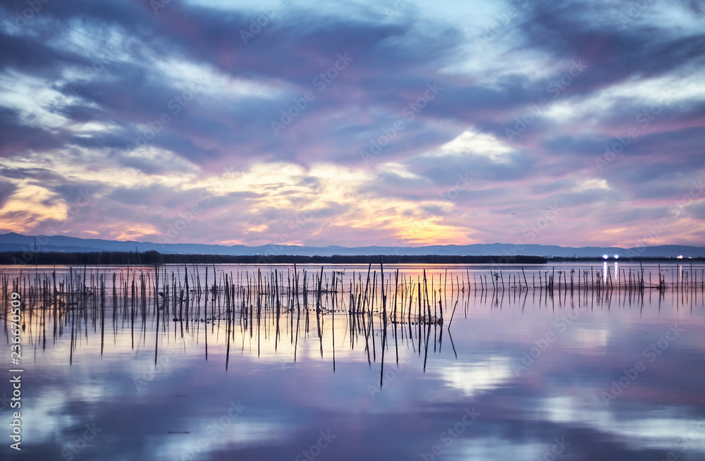 Sunset in the calm waters of the Albufera de Valencia, Spain. Sunset in the calm waters of the Albufera de Valencia, Spain.