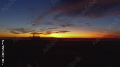 Dune Buggies driving in front of a beautiful desert sunset