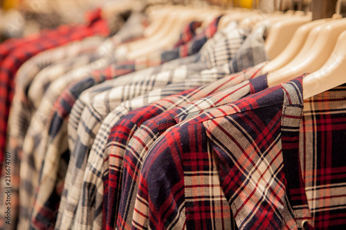 Clothes hang on a shelf . Cloth Hangers with Shirts. Men's stylish clothes