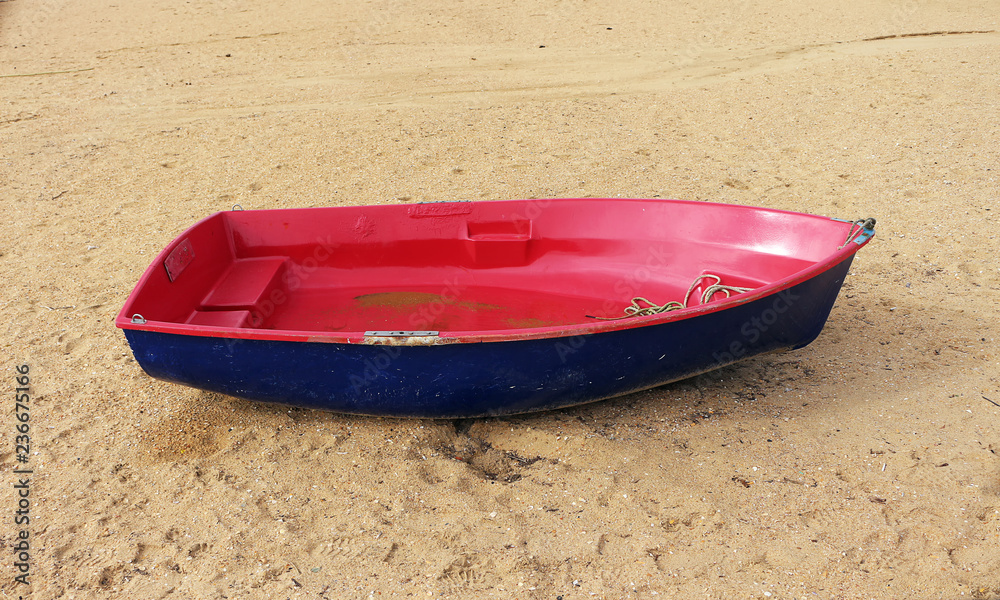 rowing boat stranded on the beach sand