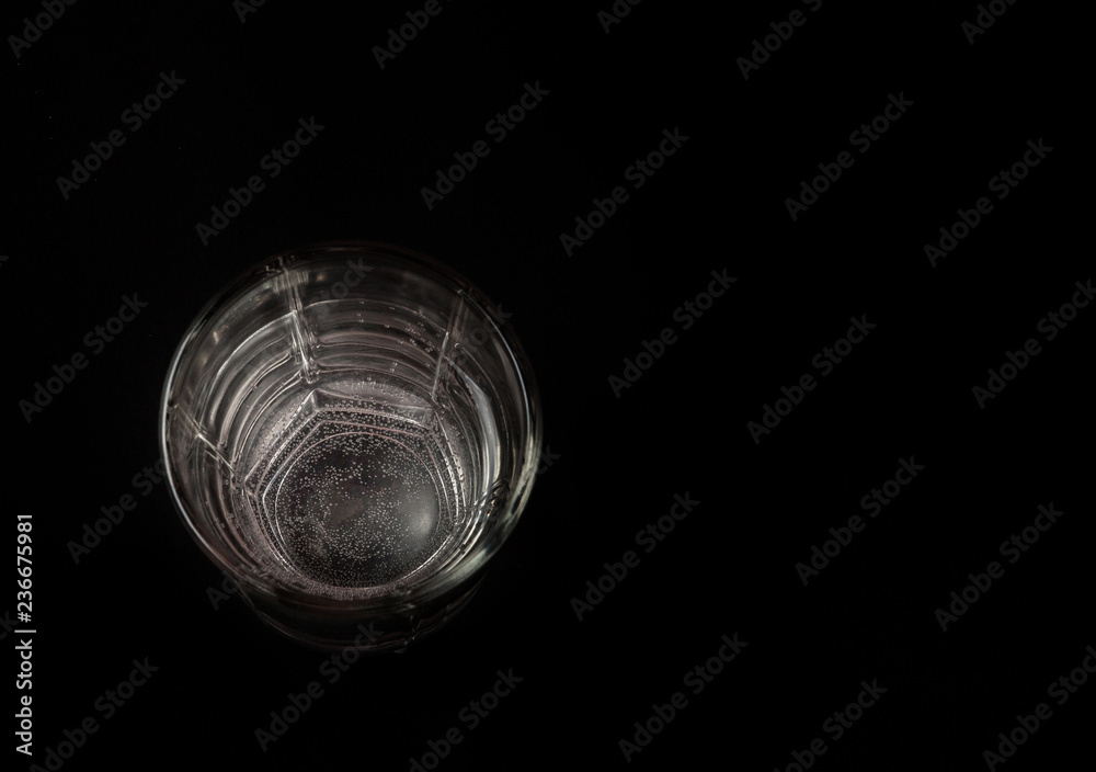 a glass of water on a black background, a place for the text. top view a glass of water on a black background, a place for the text. top view