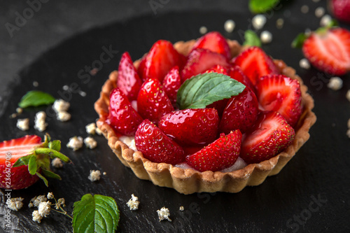 Pastry berry tart. Delicate crispy, crumbly dessert with strawberries and mint. Assorted Confectionery Range. photo