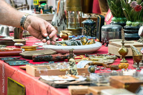 Male hand looking for old objets at a retro - vintage street market in Split, Croatia. photo