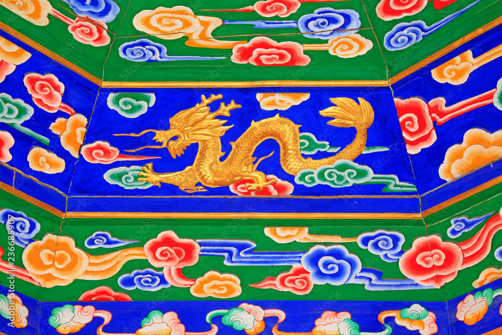 colored drawing gold dragon on wooden board