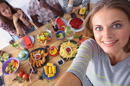 Group of people doing selfie during lunch. Self. Friends. Friends are photographed for eating