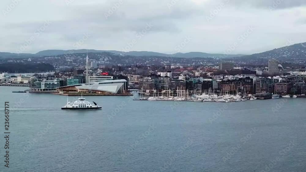 Close up aerial time lapse of a ferry boat passing by Aker Brygge and Astrup museum in Oslo, Norway Close up aerial time lapse of a ferry boat passing by Aker Brygge and Astrup museum in Oslo, Norway