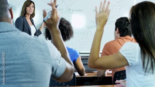 Successful Caucasian American female instructor with class multi ethnic mature students being tutored for retraining  photo